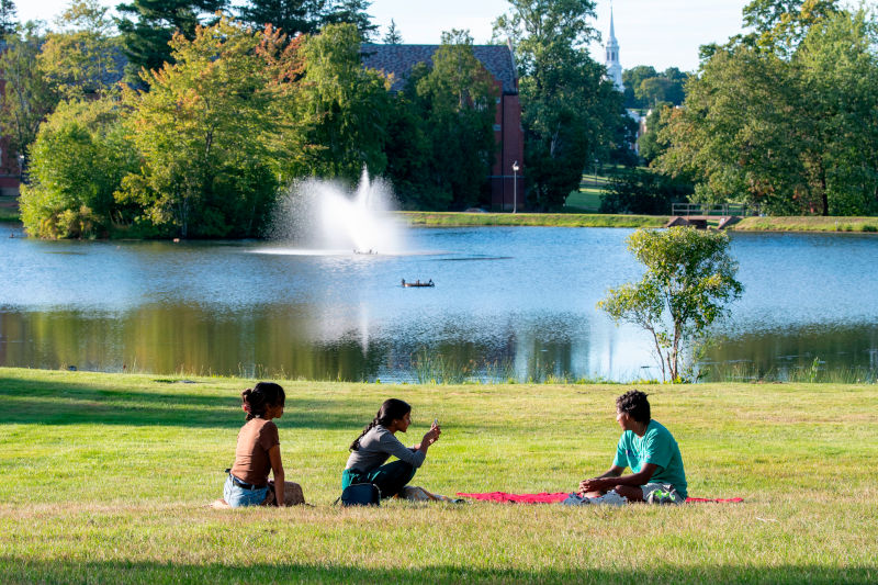 Students sitting on the lawn at Mirror Lake. Sept. 3, 2022. (Sean Flynn/UConn Photo)